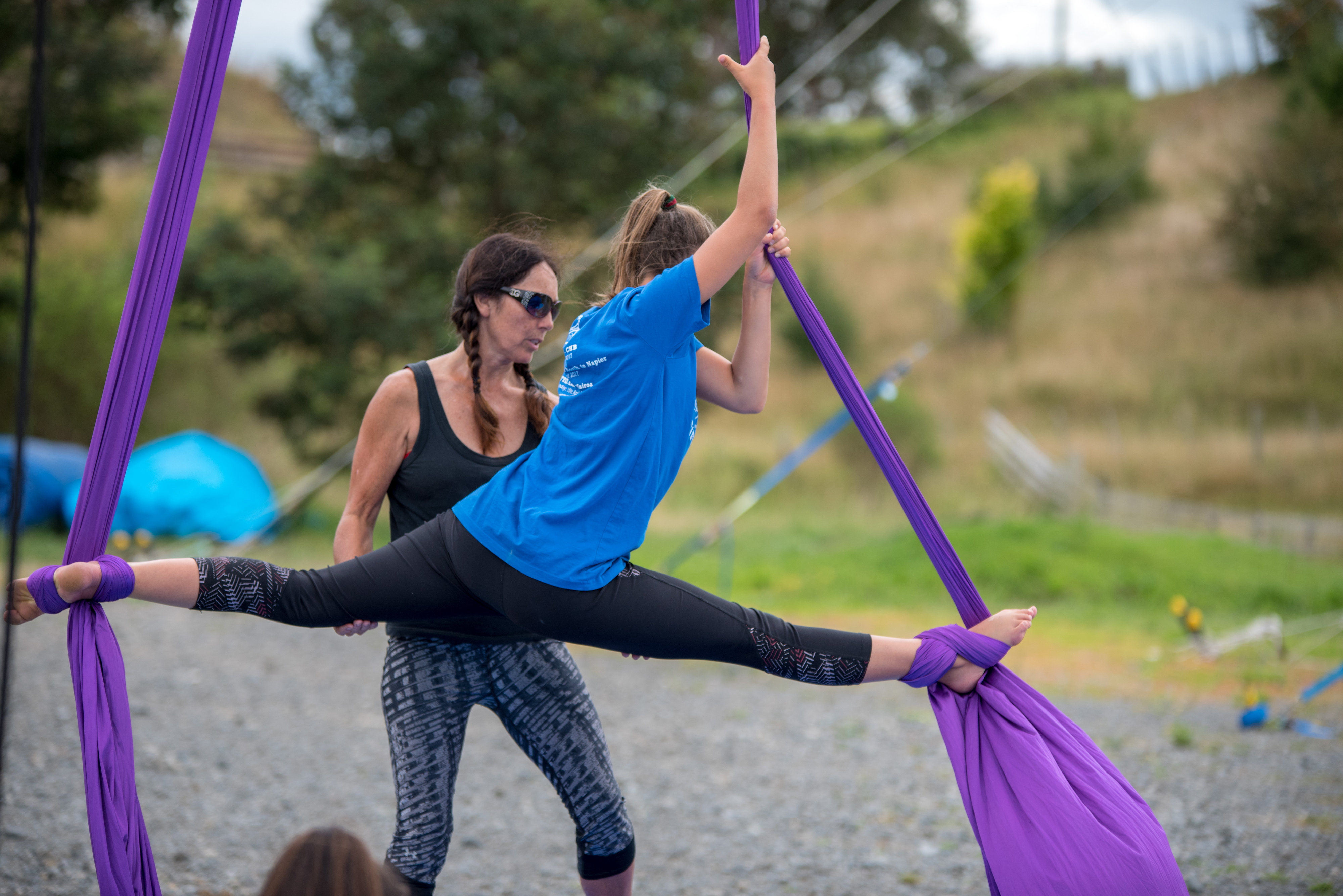 Bronwyn instructing a child on aerial silks during holiday program