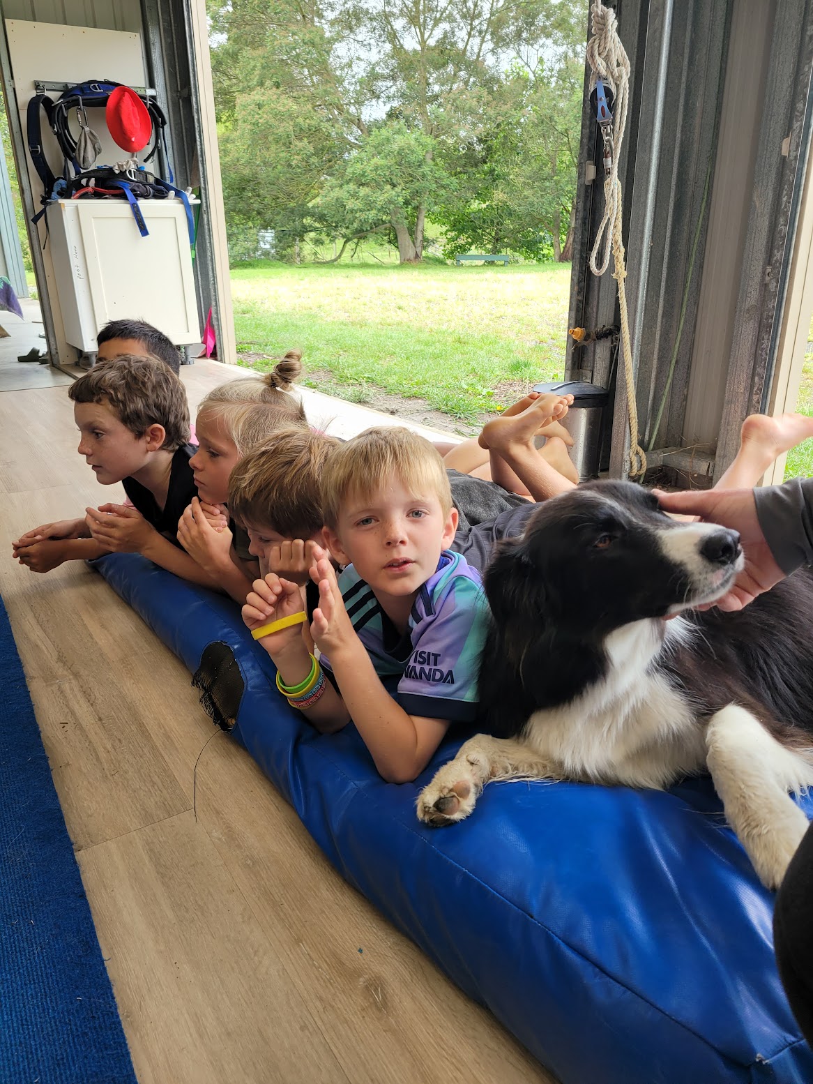 Kids relaxing with the dog between sessions