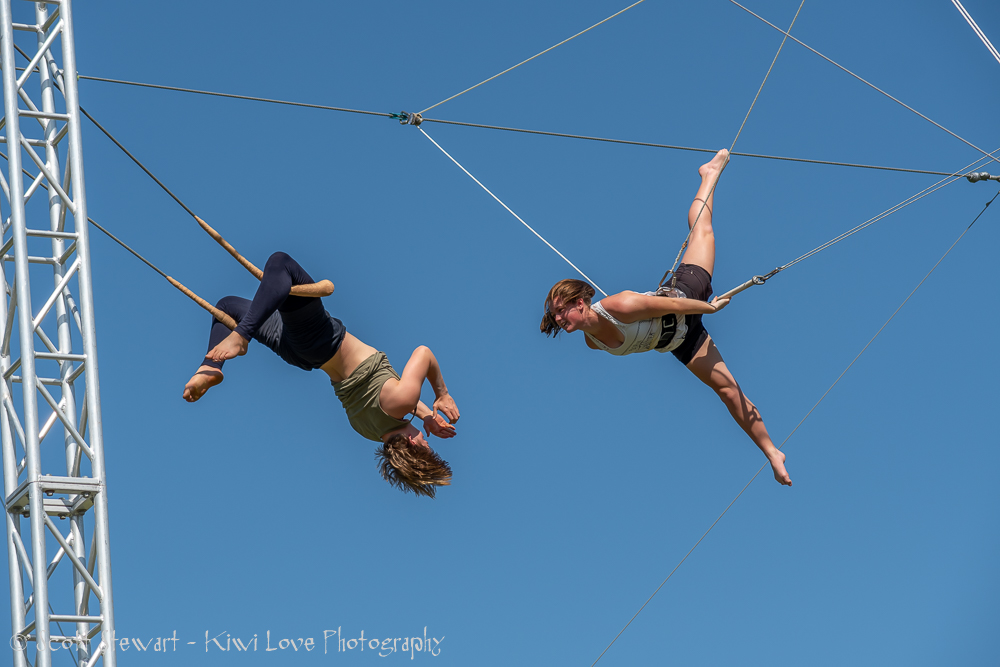 Flying trapeze catch — two aerialists mid-air